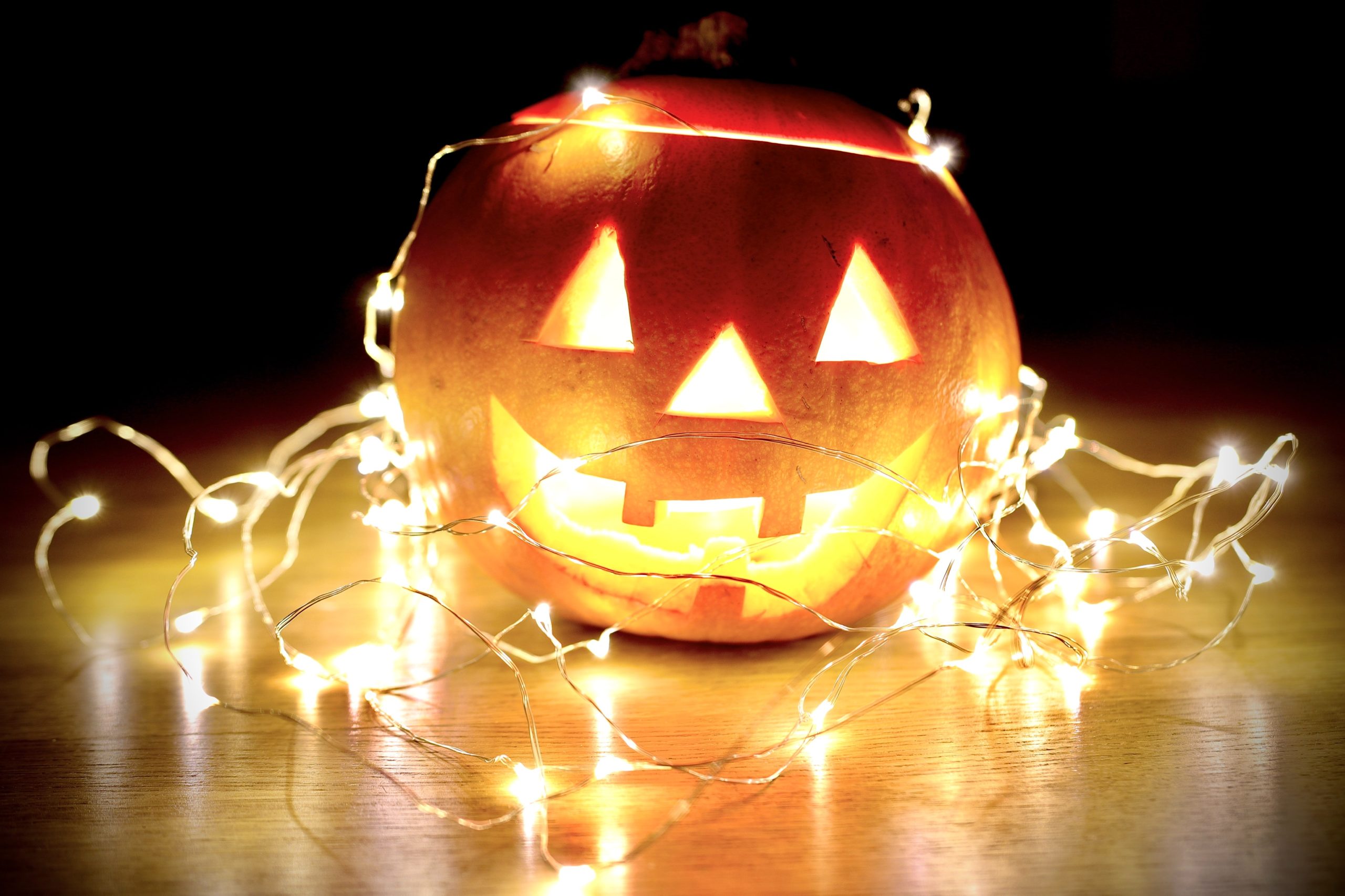 lighted string lights wrapped on Jack-O'-Lantern