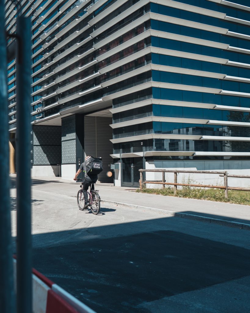 0mtjr0bvv6a man in black jacket riding bicycle on road during daytime