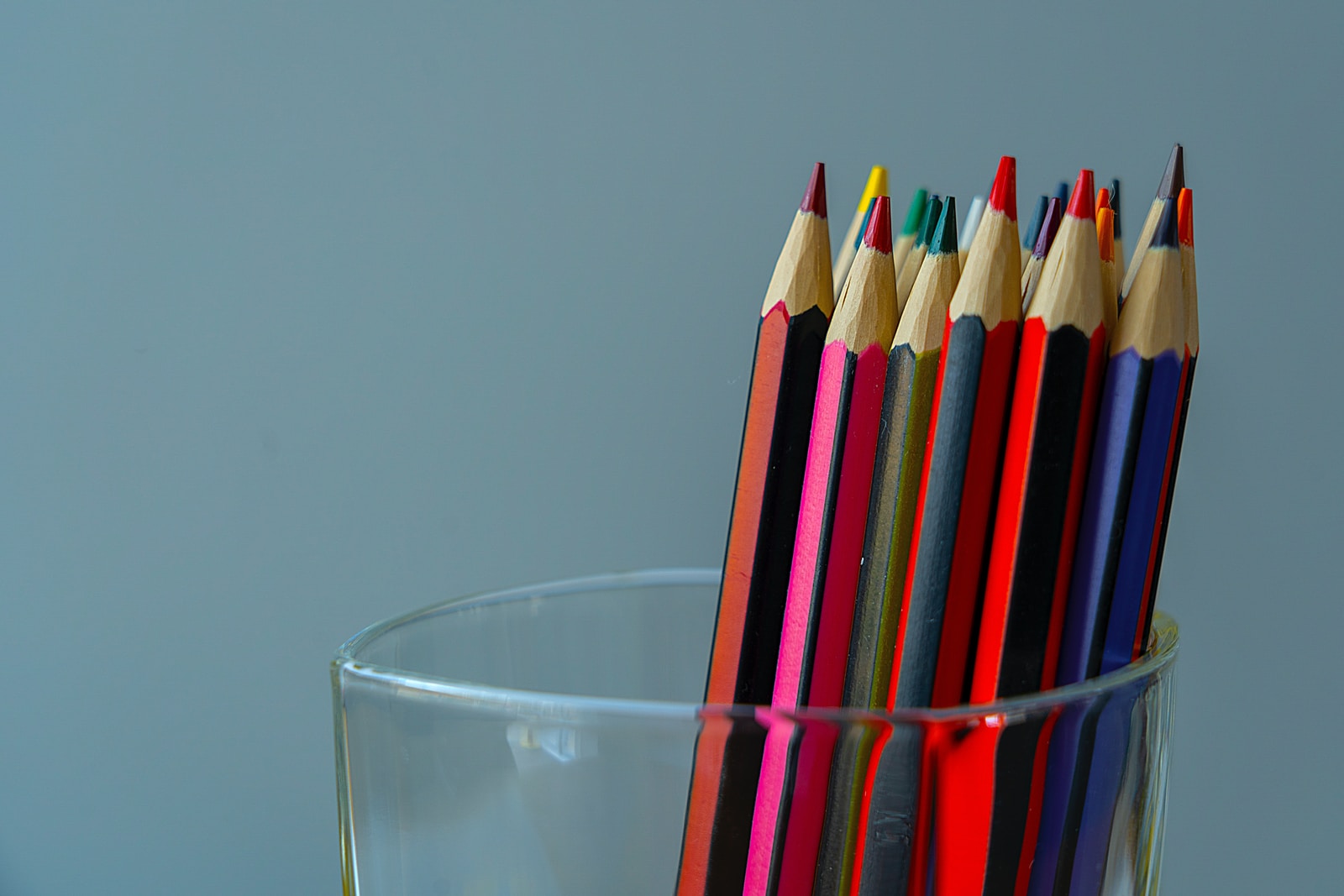 color pencils in clear drinking glass